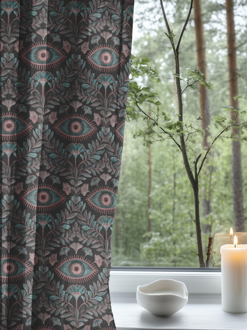 Sheer curtain panel featuring repeating sage green and blush pink evil eye motif surrounded by botanical elements on dark gray background. Linen-textured polyester fabric allows filtered light while providing elegant window covering with protective symbolism for Victorian or gothic interiors.